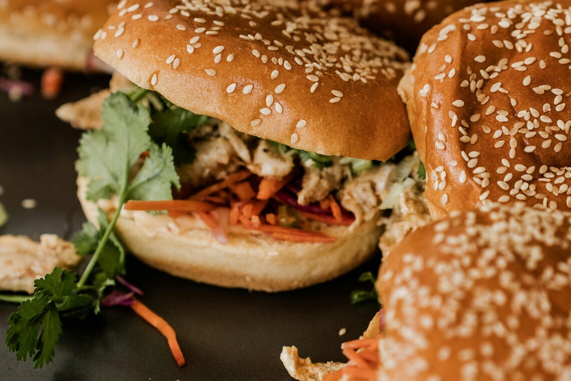 Pulled chicken sliders with slaw on sesame seed buns