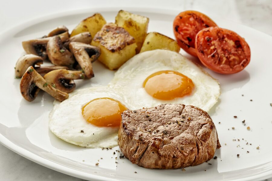 Steak with two fried eggs and home fries
