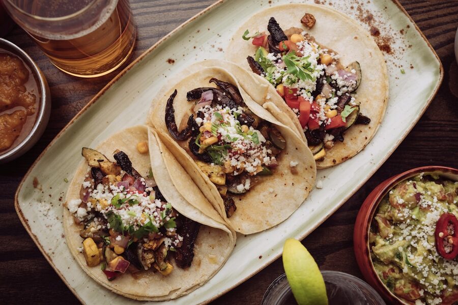 Three tacos on a board